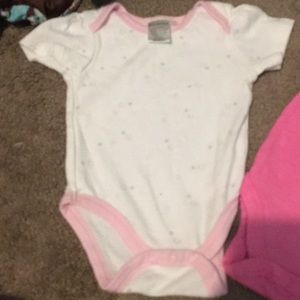 2 onesies two paired of pants and a hat